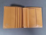 a close up of a wallet on a table on a table