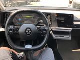 the interior of a car with a person sitting in the driver ' s seat