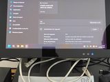 a computer monitor sitting on a desk with a keyboard and mouse