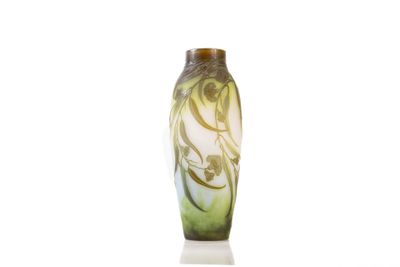 a green vase with a design on it sitting on a white surface