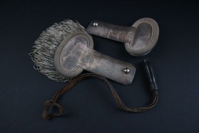 two brushes that are sitting on a black surface