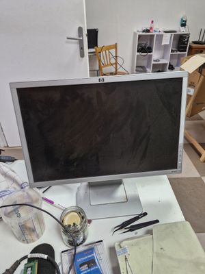 a computer monitor sitting on top of a white desk