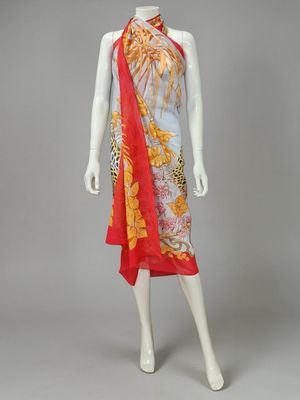 a mannequin wearing a red and yellow dress with a floral print