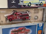 three toy firetrucks on top of each other on a table