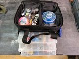 a black bag filled with items sitting on the floor