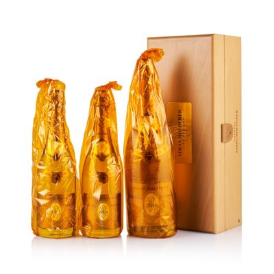 three bottles of beer sitting next to each other in front of a cardboard box