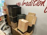 many boxes of food sitting on a table in a room