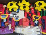 a lot of soccer jerseys and gloves on the couch