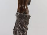 an image of a statue of a woman with her back to the camera