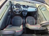 the interior of a small car with two seats and a steering wheel