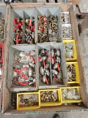 a box full of assorted metal parts on a table