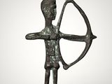 a bronze statue of a man holding a bow and arrow