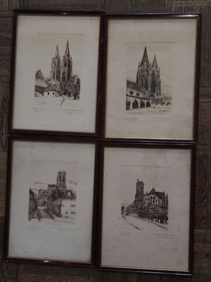 four framed drawings of a church and a church with a clock on the wall