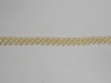 a close up of a bracelet on a white surface