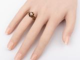 an image of a woman ' s hand with a ring on it