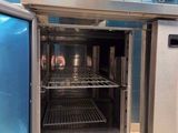 an open oven in the middle of a kitchen with blue tiles