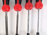 six red and black screwdrivers are lined up on a white surface