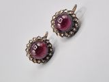 a pair of ruby and diamond earrings