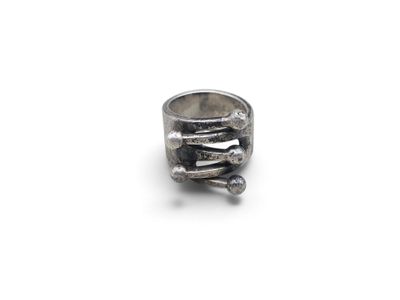 a close up of a silver ring on a white surface