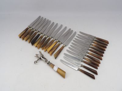 several different types of knives are lined up on a white surface