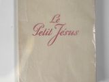 an old book with red writing on it sitting on a white surface