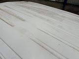 a white car that has been painted white and is parked in a parking lot