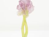 purple flower in a green vase on a white background