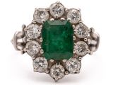 an emerald and diamond cluster ring