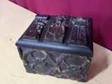 an old wooden box sitting on top of a table next to a purple wall