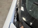 a car that is parked in a garage with its door open