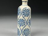 an old blue and white vase sitting on top of a table
