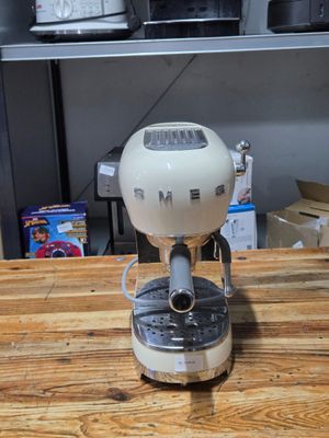 a coffee maker sitting on top of a wooden table