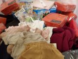 a pile of clothes and other items on the floor