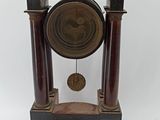 a clock that is sitting on a table next to a key