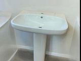 a white sink and a bathtub in a bathroom