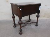 a small wooden table with a drawer on top of it
