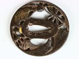 a metal object with a bird on it on a white surface