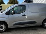 a silver van that is parked in a parking lot