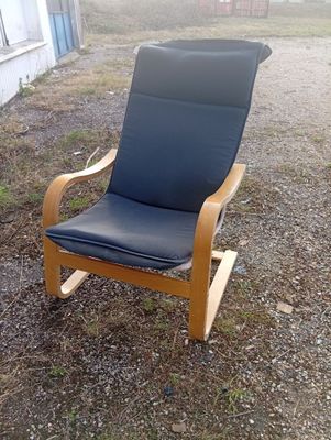 a black chair that is sitting in the dirt