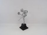 statue of a woman holding a tennis racquet on a marble base