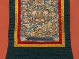 a close up of a quilted wall hanging on a wall