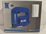 the box is open to show the contents of the electric jig saw