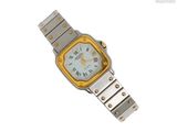 une montre-bracelet en argent et en or avec un cadran jaune