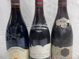 three bottles of wine are lined up on a table