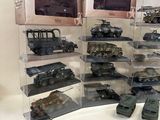 a lot of toy military vehicles on display on a table