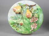 a plate with fruit on it with flowers and leaves