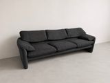 black velvet sofa in a white room with a white wall