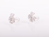 a pair of diamond earrings on a white background