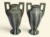 two vases that are sitting next to each other on a table