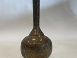 an antique bronze vase with a decorative design on the top